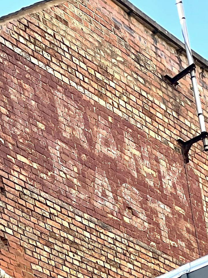 Frank East ghost sign in Queen Street