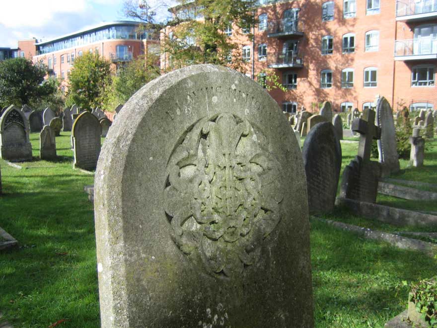 Grave overlooked by flats